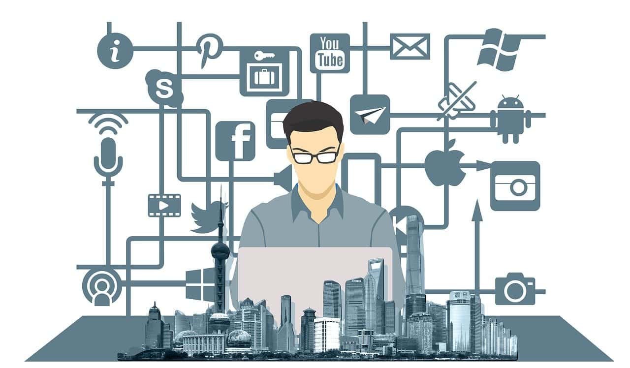 Man writing at a laptop with social media icons and buildings