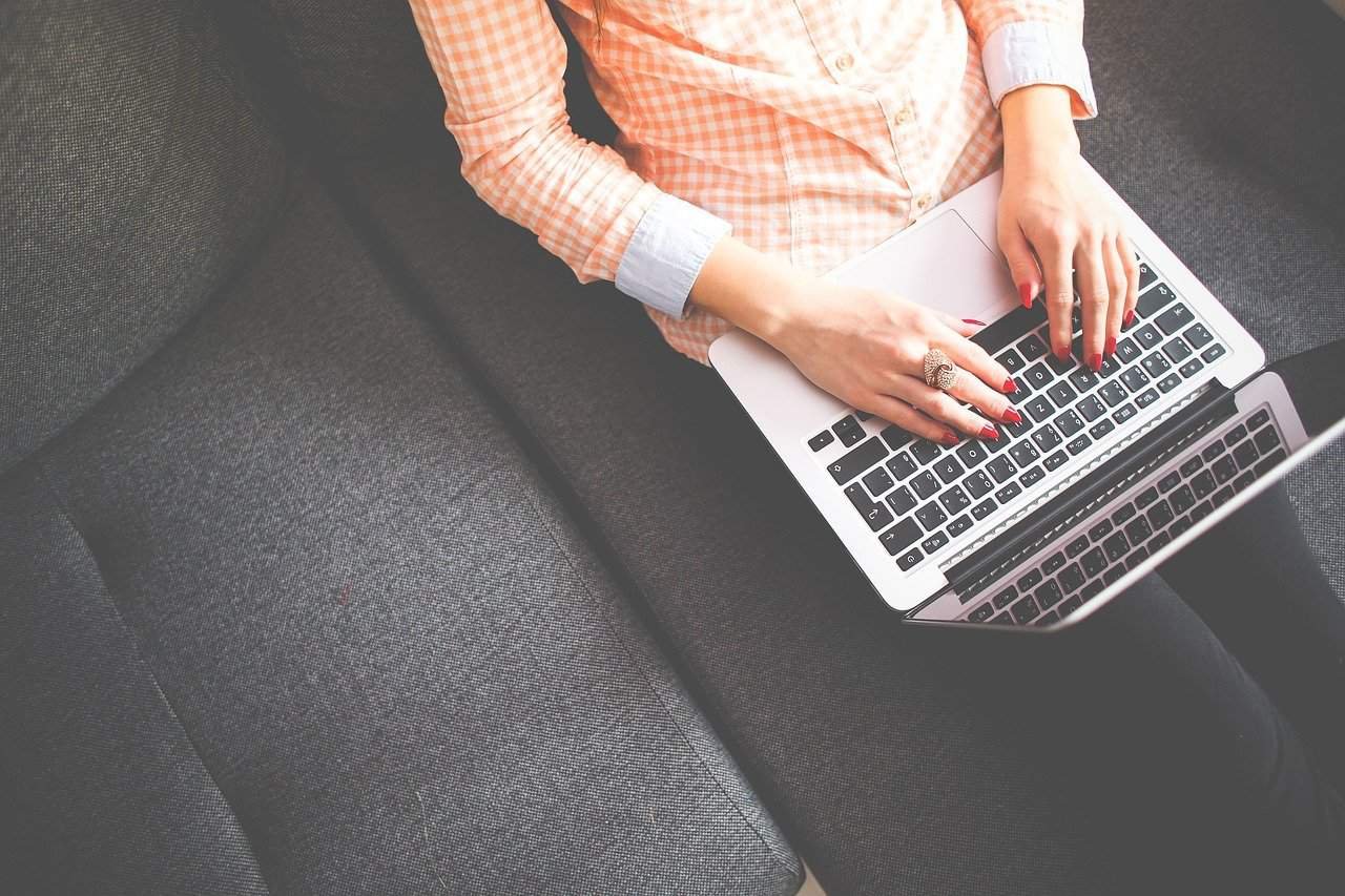 Woman with laptop in couch