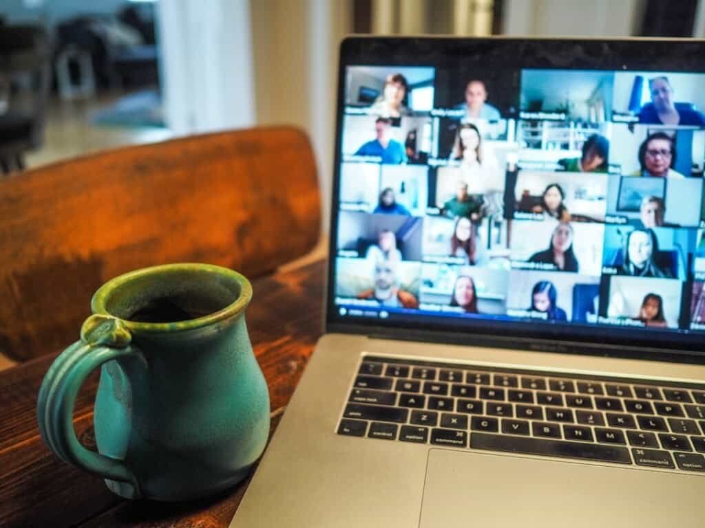 macbook pro displaying group of people webinar