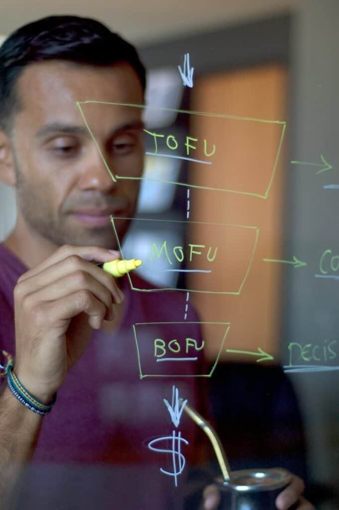 man writing sales funnel